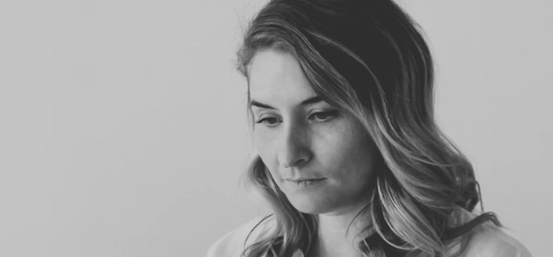 A neurodivergent founder pausing at her laptop, mid-decision about where to even begin with AI