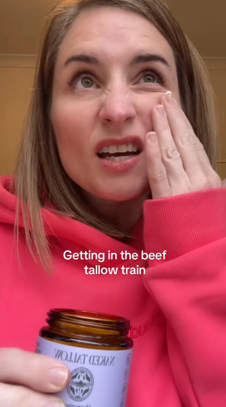 Mia in a pink hoodie trying a skincare product: Getting in the beef tallow train